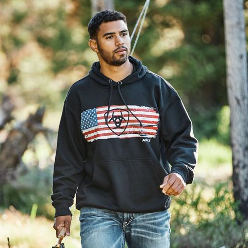 Man in american flag ariat hoodies in forest